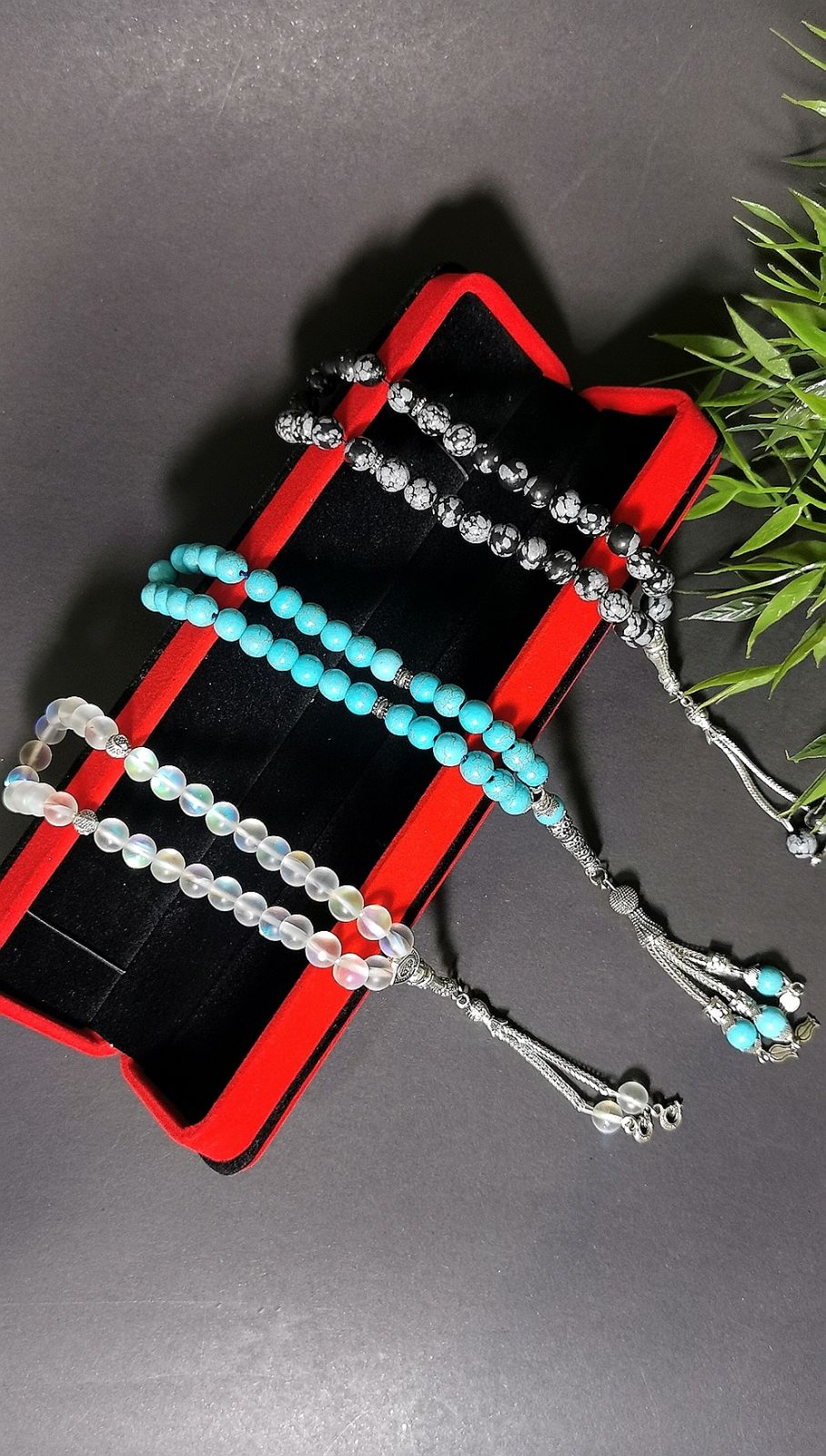 Display of three rosaries with 100% natural stones 