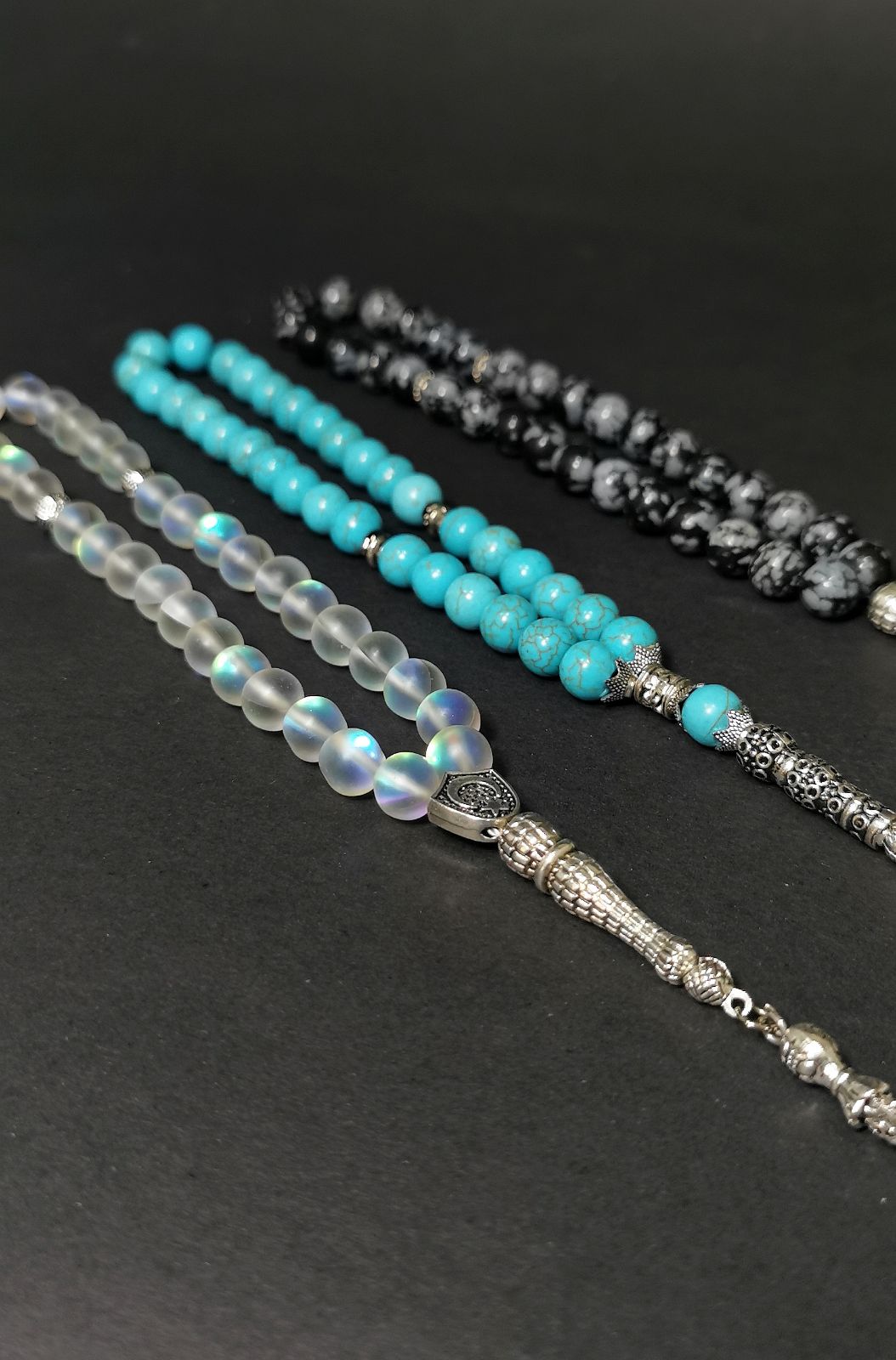 Display of three rosaries with 100% natural stones 